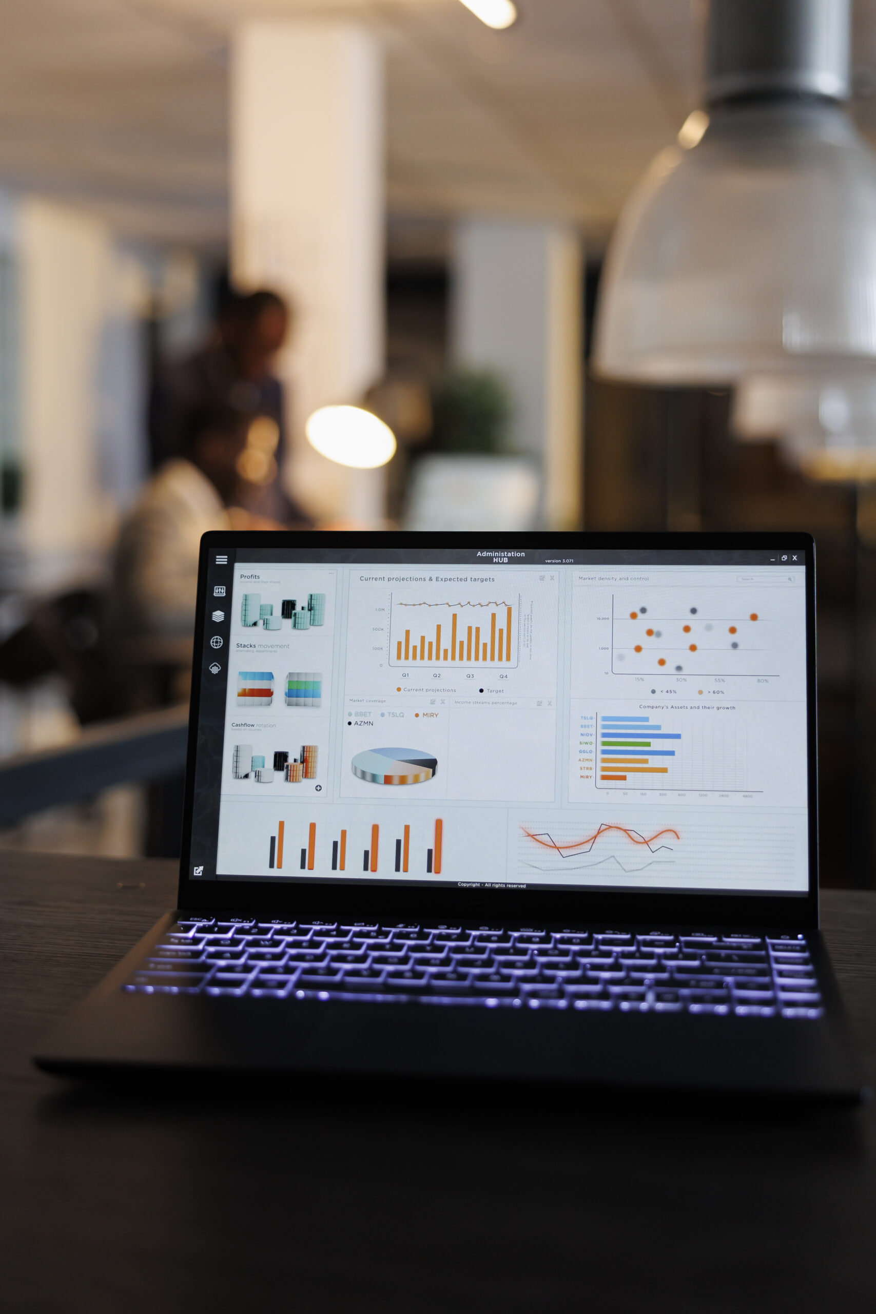 Laptop computer with marketing statistics graphs on screen